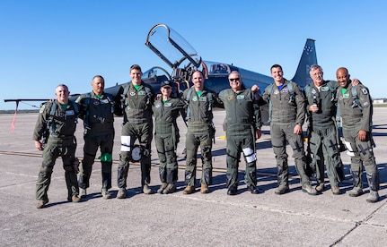 Air Force T-38 pilots assigned to the 560th Flying Training Squadron pose for a group photo with Capt. Gregg Hanson, Maj. Richard Bates and Janine Sijan after receiving their freedom flight at Joint Base San Antonio-Randolph March 25. The Freedom Flyer Reunion is an annual celebration recognizing the service of Air Force Prisoners of War during the Vietnam War.
