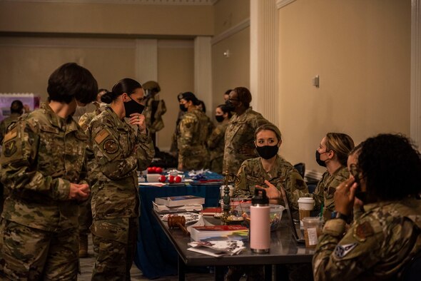 Military members and civilians of the Seymour Johnson community socialize during the Military Women Air Force Specialty Code Showcase at Seymour Johnson Air Force Base, North Carolina, March 26, 2021.