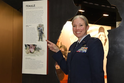 Illinois Air National Guard Capt. Jennifer Weitekamp poses for a photo next to the Women in the Air Force exhibit at the National Museum of the U.S. Air Force March 5.