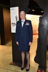 Illinois Air National Guard Capt. Jennifer Weitekamp poses next to the Women in the Air Force exhibit honoring her accomplishment at the National Museum of the U.S. Air Force March 5.