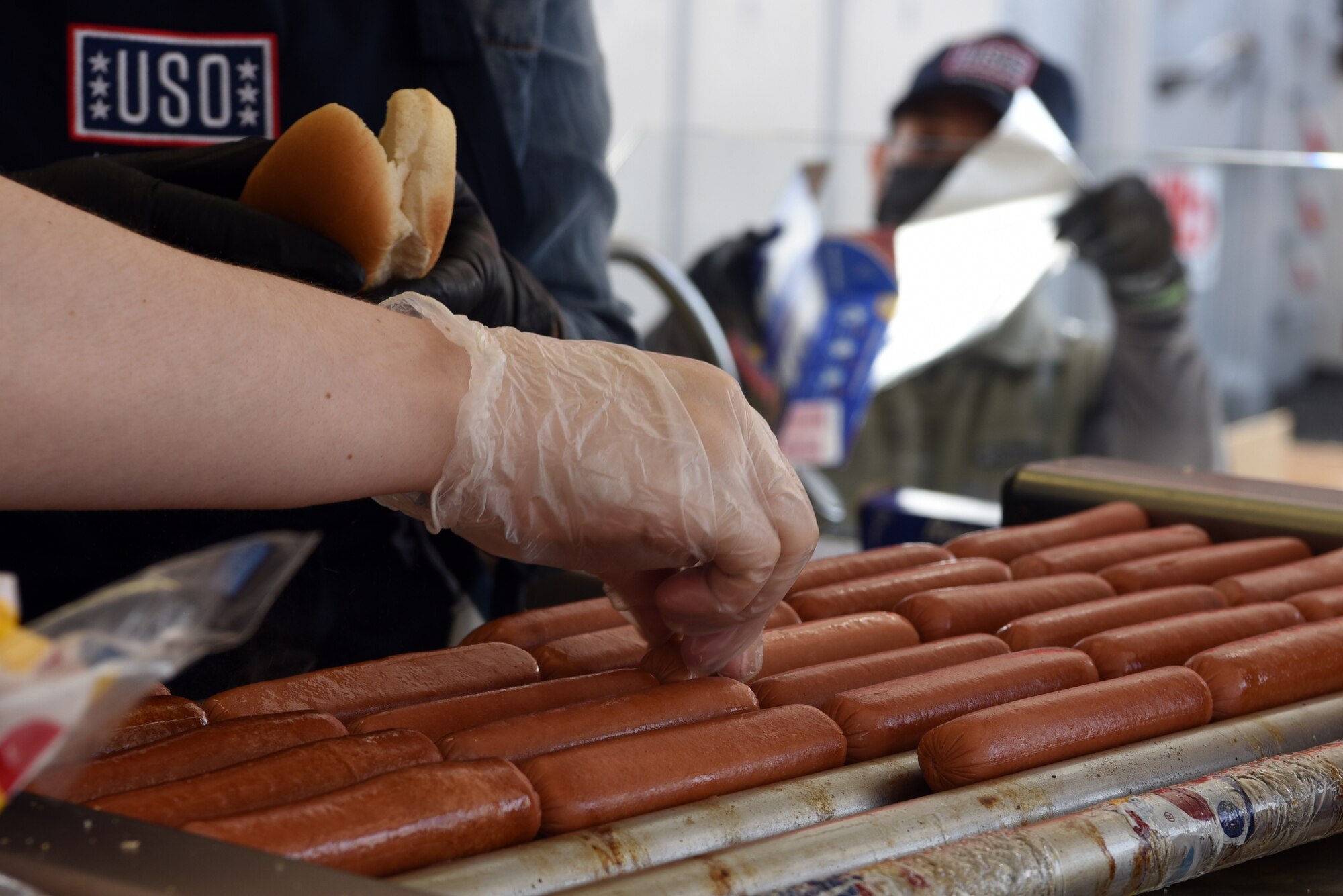 USO Kaiserslautern volunteers cook hot dogs for U.S. Air Force Airmen assigned to the 86th Logistics Readiness Group.