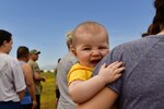 Woman holds smiling baby