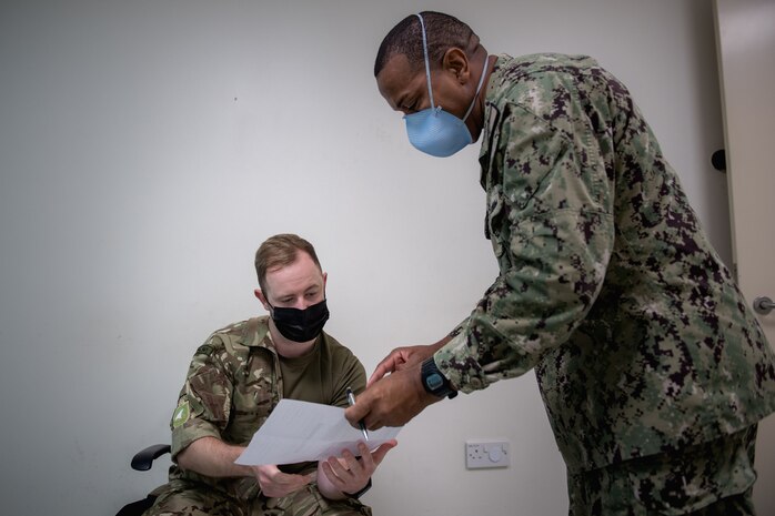 210330-N-KZ419-1114 NAVAL SUPPORT ACTIVITY BAHRAIN (March 30, 2021) – Hospital Corpsman 2nd Class Amanda Reyna, right, prepares to administer a COVID-19 vaccine to Information Systems Technician 2nd Class Issac Patrick onboard Naval Support Activity Bahrain, March 30. The vaccination effort, which began in early January, has resulted in approximately 12,871 doses of the two-shot Moderna and single-shot Johnson & Johnson vaccines being administered to military and civilian personnel throughout the 5th Fleet area of operations. (U.S. Navy photo by Mass Communication Specialist 3rd Class Dawson Roth)