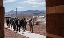 Acting Secretary of the Air Force Roth is escorted to a building.