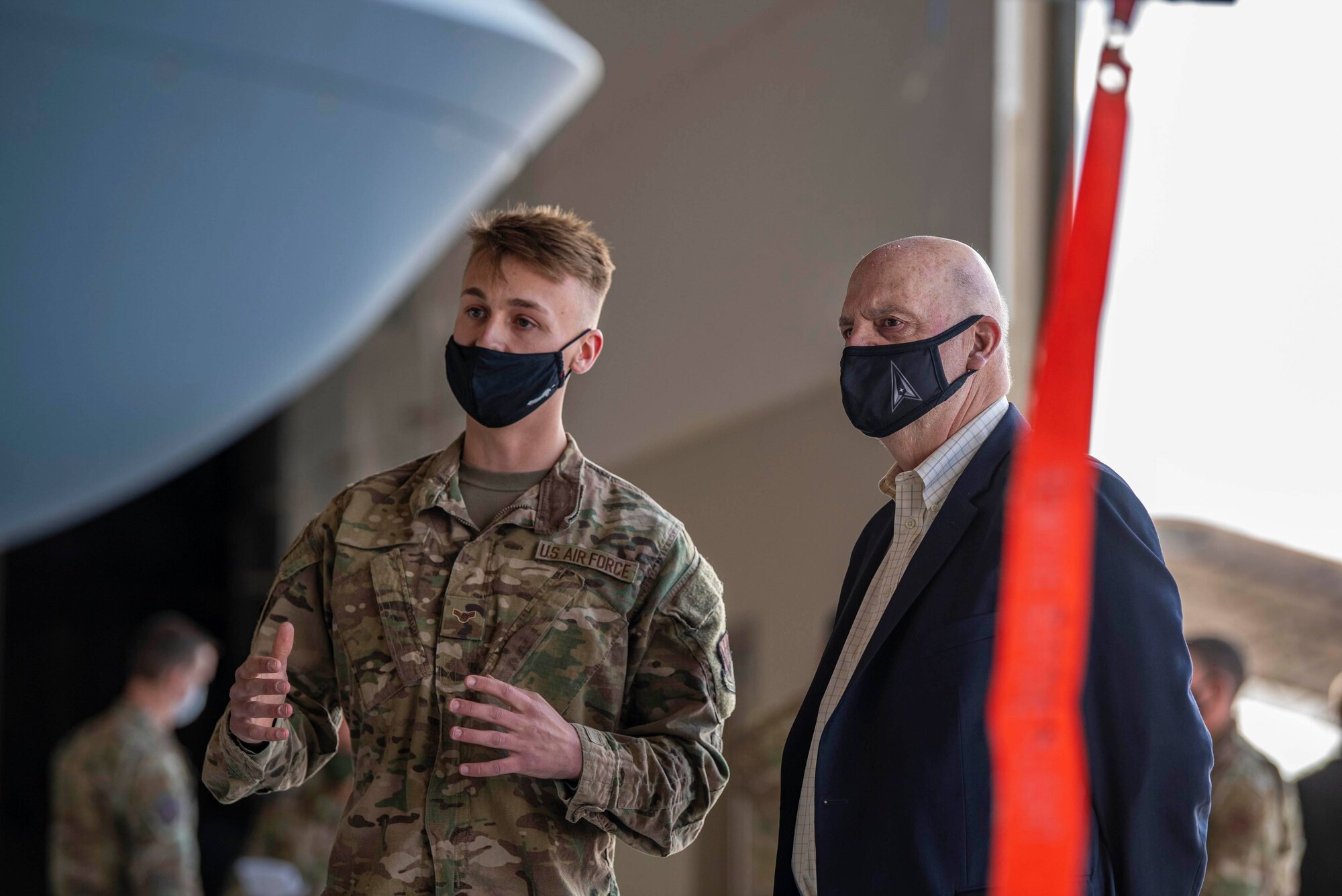 Secretary of the Air Force Roth is briefed by an Airman.