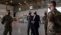 Acting Secretary of the Air Force John Roth interacts with Airmen in a hangar.