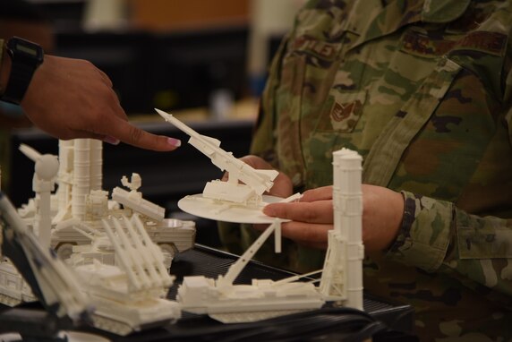 U.S. Air Force Airman 1st Class Neisha Navarro Montanez, 315th Training Squadron student, discusses a three-dimensional model with Tech. Sgt. Mollie Whitley, 315th TRS instructor. The three-dimensional models were designed to help students in the geospatial intelligence course fully understand the types of equipment they have to recognize when looking at imagery. (U.S. Air Force photo by Senior Airman Ashley Thrash)