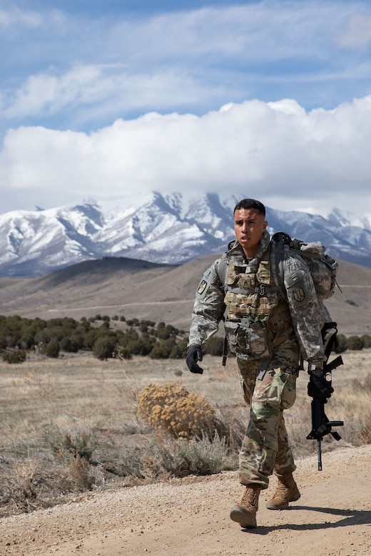 soldier marches with a ruck sack