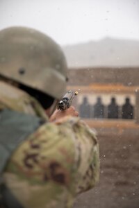soldier shoots pistol at target