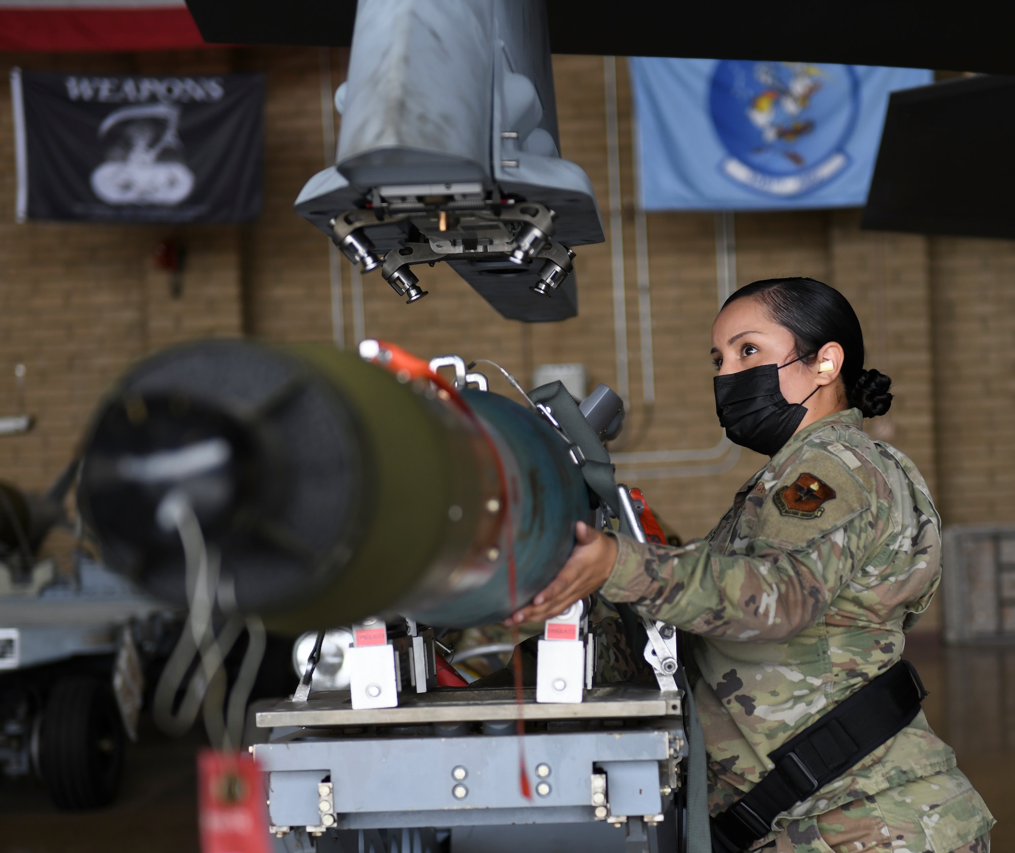 Staff Sgt. Cindy Guillen, 56th Component Maintenance Squadron weapons load technician, loads a GBU-12 Paveway II laser-guided bomb on an F-35A Lightning II during an exhibition load March 25, 2021, at Luke Air Force Base, Arizona. Guillen spoke about participating in the load to bring attention to the fact that only three women from her career field have made it to the rank of chief master sergeant since the inception of the Air Force. Diversity allows the Air Force to capitalize on all available talent by enabling a culture of inclusion. (U.S. Air Force photo by Staff Sgt. Amber Carter)