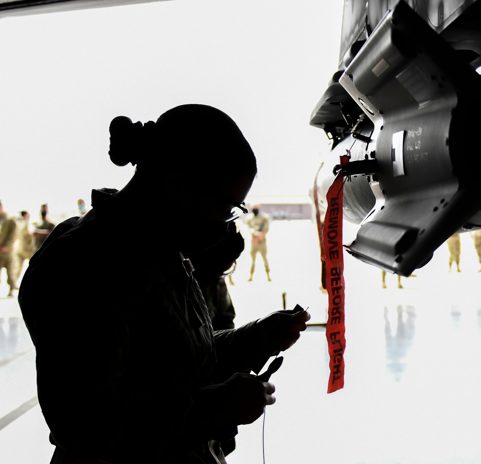 Airman 1st Class Melanie Morgan, 63rd Aircraft Maintenance Unit weapons load technician, prepares to install the guidance section of a GBU-12 Paveway II laser-guided bomb March 25, 2021, at Luke Air Force Base, Arizona. Morgan was part of a three-person team made of female Airmen from different units during the Women of Weapons Exhibition Load, which highlighted the capabilities of women in the weapons load careerfield. Diversity allows the Air Force to capitalize on all available talent by enabling a culture of inclusion. (U.S. Air Force photo by Staff Sgt. Amber Carter)