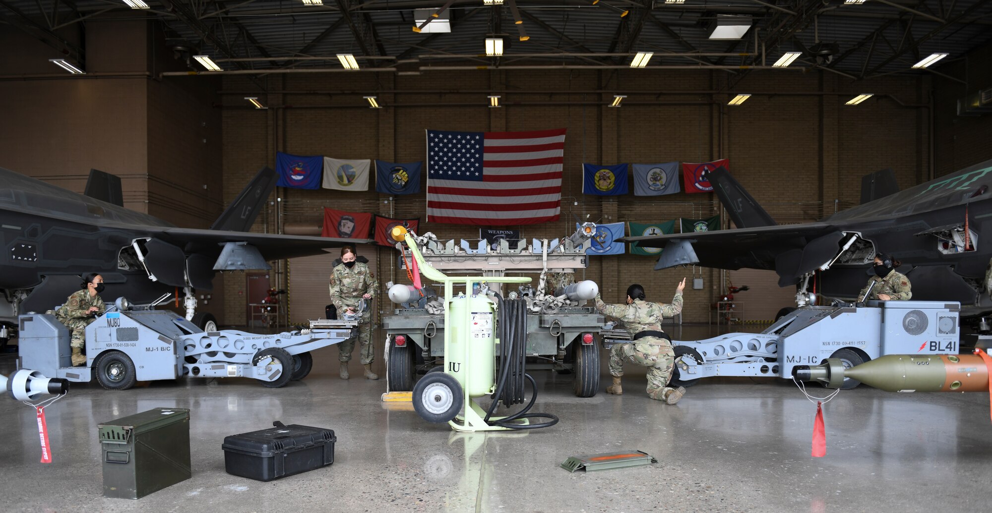 Airmen from multiple 56th Fighter Wing and 944th FW aircraft maintenance units participate in the Women of Weapons Exhibition Load March 25, 2021, at Luke Air Force Base, Arizona. The exhibition load involved three teams made up of women from different backgrounds, units and ranks loading weapons on the F-35A Lightning II and the F-16 Fighting Falcon. Diversity allows the Air Force to capitalize on all available talent by enabling a culture of inclusion. (U.S. Air Force photo by Staff Sgt. Amber Carter)