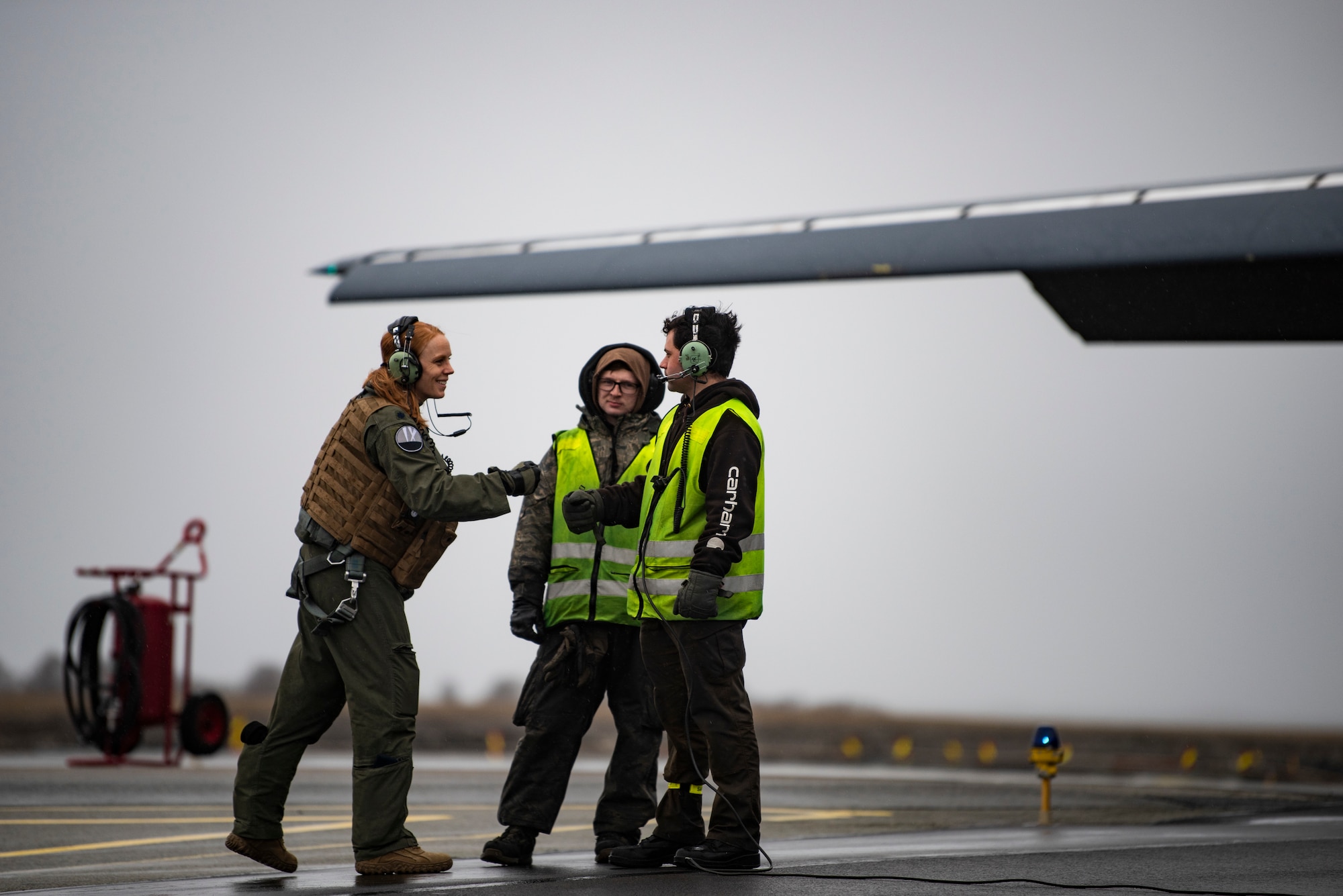 A pilot assigned to the 9th Expeditionary Bomb Squadron greets two crew chiefs at Ørland Air Force Station, Norway, March 23, 2021. Two B-1s participated in Amalgam Dart, a joint integration training mission consisting of a series of potential real-world scenarios designed to bolster U.S. aerospace warning and defense readiness. (U.S. Air Force photo by Airman 1st Class Colin Hollowell)