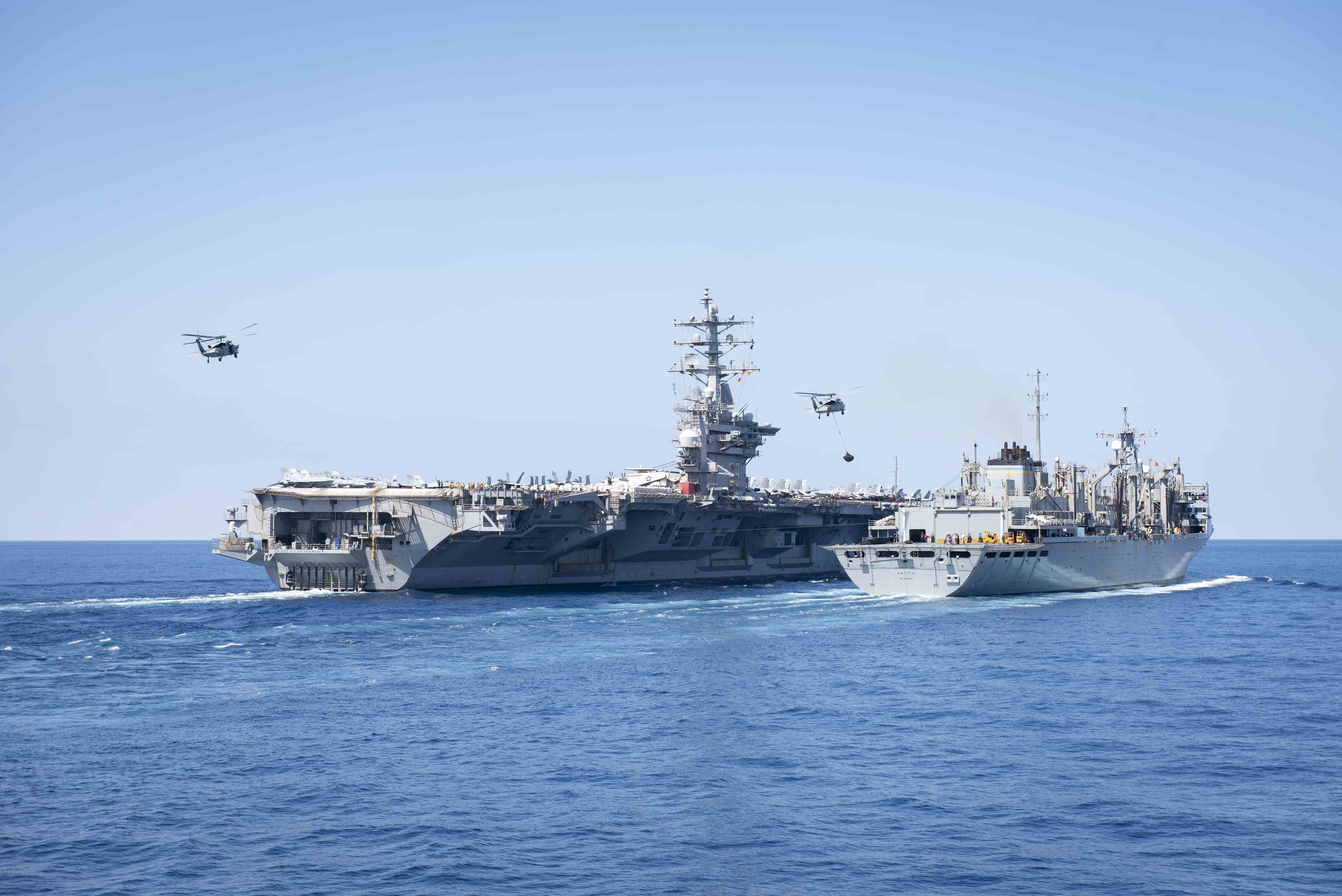 USS Dwight D. Eisenhower (CVN 69) conducts a replenishment-at-sea with USNS Arctic (T-AOE 8) alongside USS Mitscher (DDG 57), March 27, 2021.