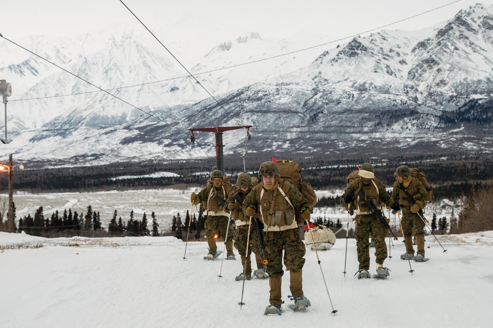 Marines with Combat Logistics Regiment 25, 2nd Marine Logistics Group, tow Ahkio sled containing cold weather gear, at U.S. Army Northern Warfare Training Center, Alaska, February 20, 2018 (U.S. Marine Corps/Sean M. Evans)