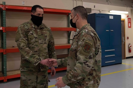 Maj. Gen. Torrence Saxe, adjutant general of the Alaska National Guard, right, awards Tech Sgt. Ernesto Torres a coin during a visit to Eielson Air Force Base, Alaska, March 23, 2021. (U.S. Army National Guard photo by Victoria Granado)