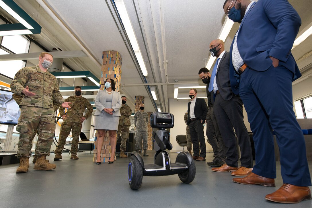 Second Lt. Johann Johnson, 436th Airlift Wing innovation lab director, briefs Delaware State University faculty and students on self-balancing transportation at the Bedrock innovation lab on Dover Air Force Base, Delaware, March 25, 2021. The lab staff plans to implement the autonomous unit to help with maintenance operations and inspections. (U.S. Air Force photo by Mauricio Campino)