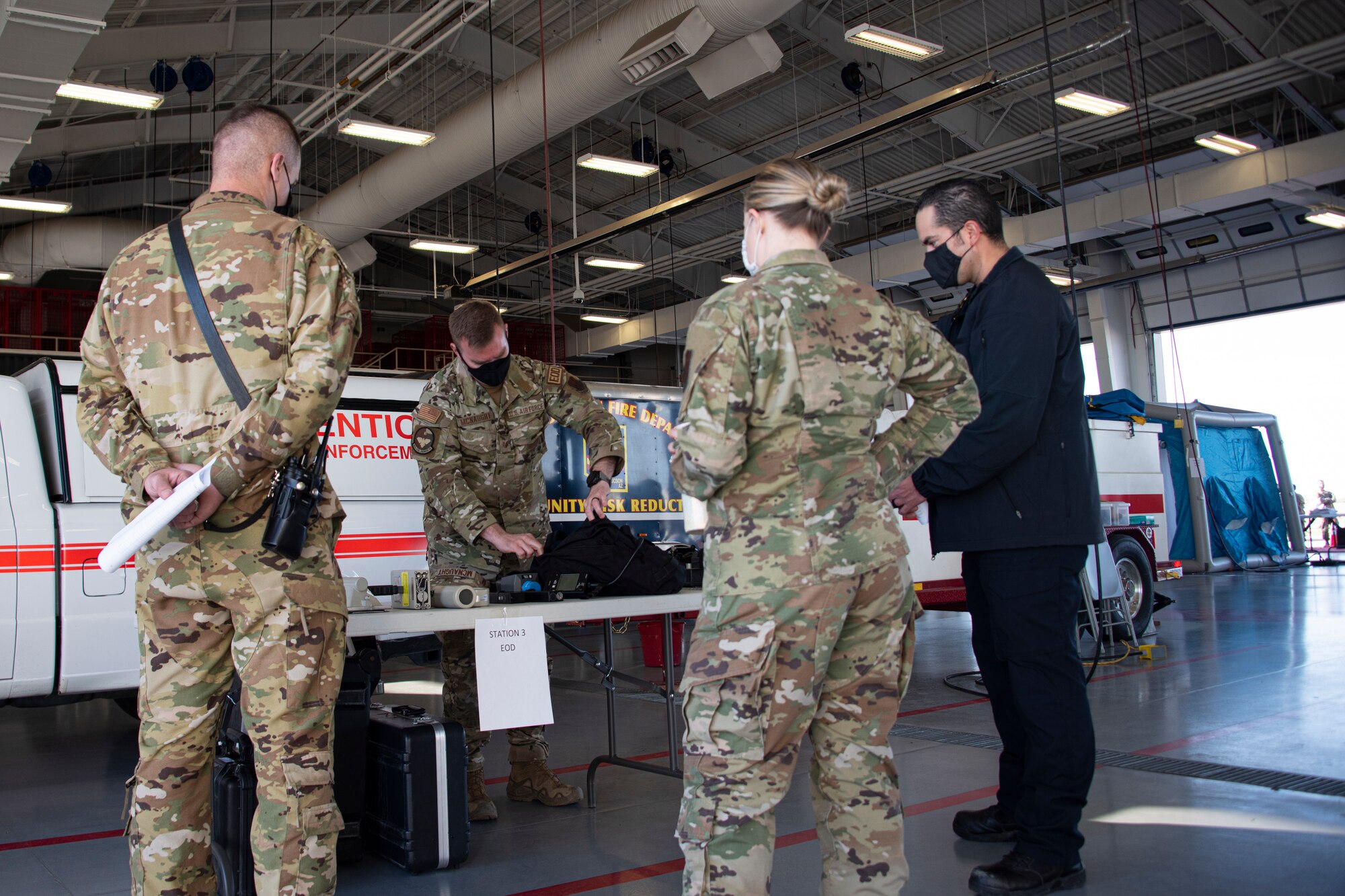 An Airman briefs other airmen on Explosive Ordnance Disposal.