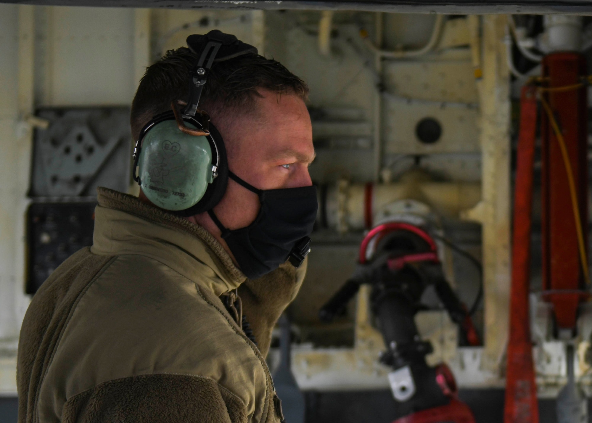 A 92nd Maintenance Squadron Airman attaches a hose to a KC-135 Stratotanker to perform hot pit refueling on Fairchild Air Force Base, Washington, March 25, 2021. Hot pit refueling shortens the amount of time spent servicing aircraft which in turn allows more aircraft to be turned over in the same amount of time. (U.S. Air Force photo by Airman 1st Class Kiaundra Miller)
