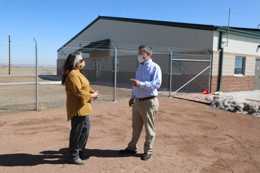 Greg Sipes (right) project engineer and contracting office representative, U.S. Army Corps of Engineers, Omaha District, Fort Carson South office, and Alice Gallegos, Army Supply Point supervisor, talk in front of the ammunition storehouse on Fort Carson, CO, March 19.