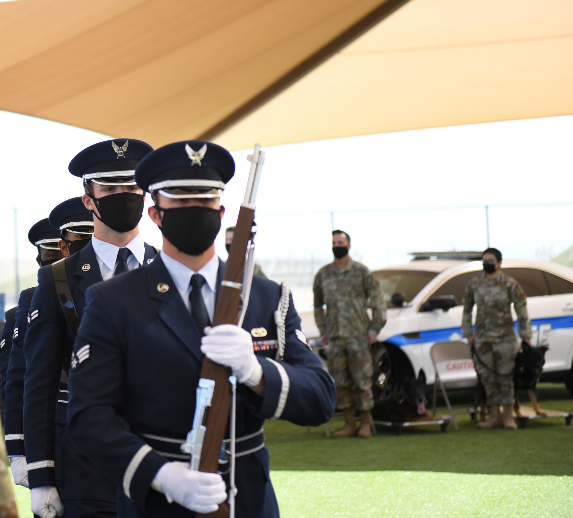 Airmen from the  56th Fighter Wing Honor Guard post the colors at a military working dog retirement ceremony March 19, 2021, at Luke Air Force Base, Arizona. Boss and Rango, 56th Security Forces Squadron military working dogs, retired after seven and eight years of service, respectively. As the Air Force prepares to retire a MWD, the dog’s handler can request to adopt the dog enabling it to live the remainder of its life as a family member. Boss and Rango will retire and live at home with their respective handler. (U.S. Air Force photo by Staff Sgt. Amber Carter)