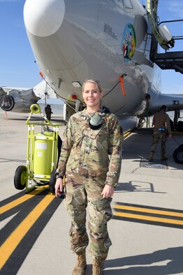 women standing in front of a plane