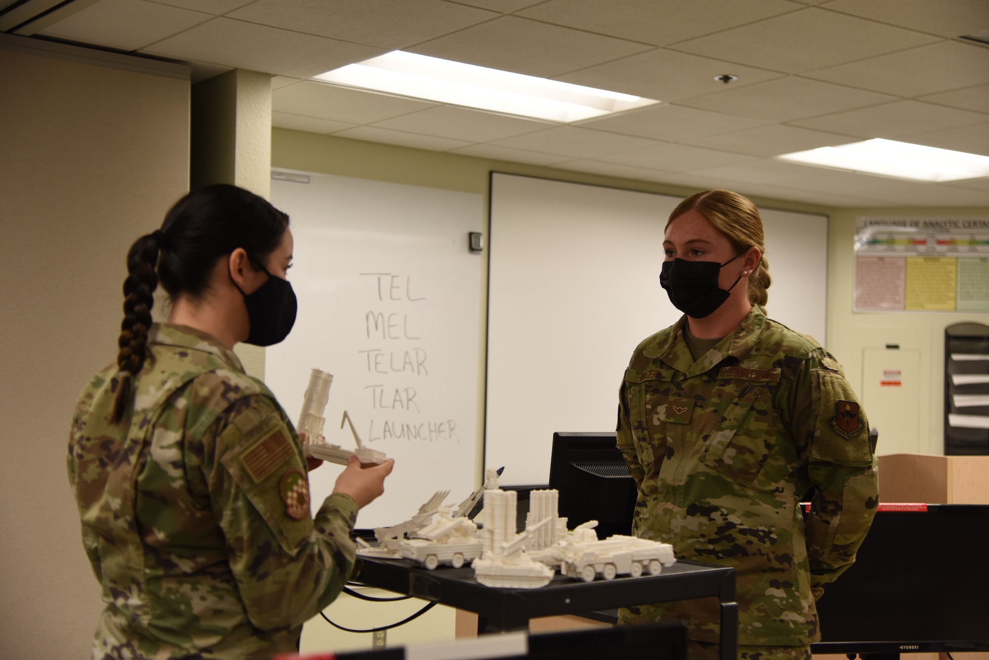 U.S. Air Force Tech. Sgt. Mollie Whitley, 315th Training Squadron instructor, quizzes Airman Mauranda Racer, 315th TRS student on her knowledge of different types of equipment. The instructors provided these models to help the students transition from power points to hands on learning. (U.S. Air Force photo by Senior Airman Ashley Thrash)
