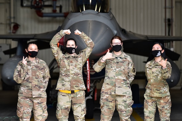 Airmen pose for a photo.