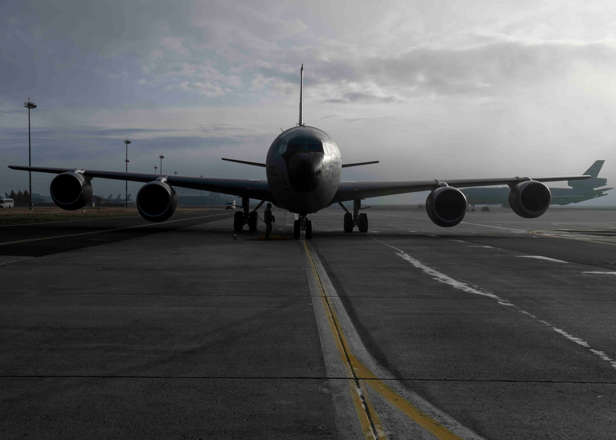 A 92nd Maintenance Squadron Airman inspects a KC-135 Stratotanker after it lands prior to a hot pit refueling operation at Fairchild Air Force Base, Washington, March 25, 2021. Hot pit refueling occurs nearly immediately after an aircraft lands, maintaining one engine remaining on during the refueling. (U.S. Air Force photo by Airman 1st Class Kiaundra Miller)