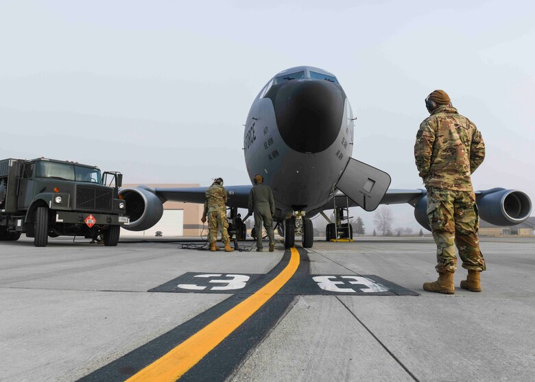 Airmen from the 92nd Maintenance Squadron perform hot pit refueling on a KC-135 Stratotanker on Fairchild Air Force Base, Washington, March 25, 2021. Hot pit refueling occurs nearly immediately after an aircraft lands, maintaining one engine remaining on during the refueling. (U.S. Air Force photo by Airman 1st Class Kiaundra Miller)