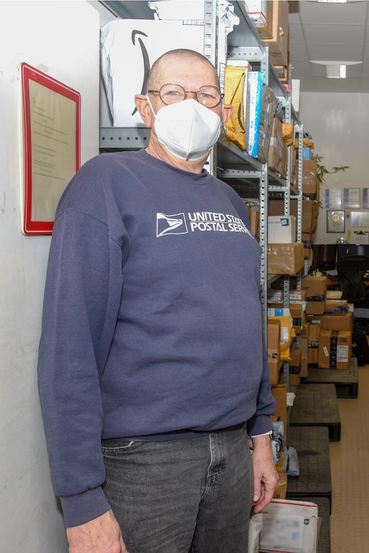 Dean Blegen, pictured here in Community Mail Room 410 at the Amelia Earhart Center in Wiesbaden, Germany January 29, 2021, served nearly 20 years as part of the U.S. Army Corps of Engineers, Europe District team working in CMR 410 before passing away on March 3, 2021 after a sudden, brief illness. Blegen was remembered by his colleagues as a caring, friendly face who made sure they always got their mail and did whatever he could to brighten people’s days. (U.S. Army photo by Alfredo Barraza)