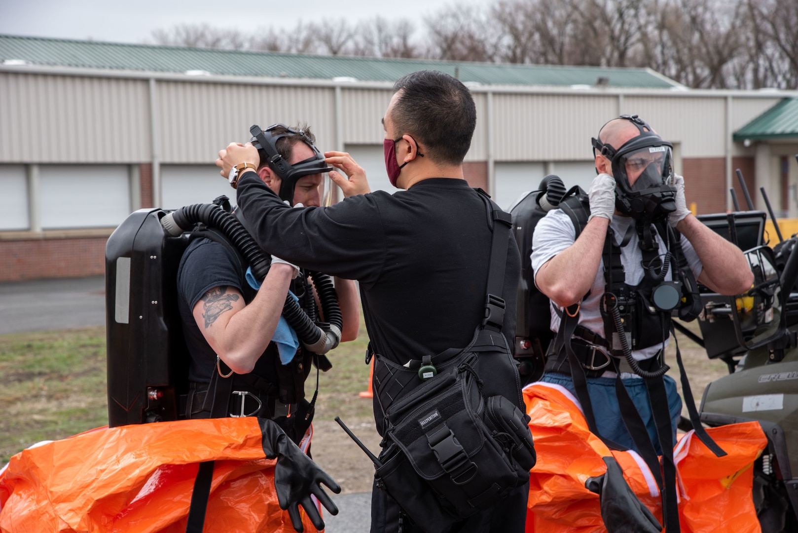 Sgt. Dan Pyo of the 14th Civil Support Team assists teammate Sgt. Justin Madore during a training exercise at the Eastern States Exposition Center in West Springfield, Mass., on March 25, 2021. The Training Proficiency Evaluation is led by U.S. Army North for a CST to validate their training and equipment every 18 months.