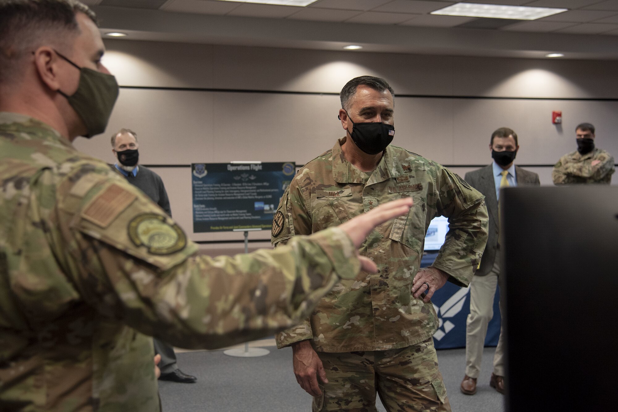 Photo of an Airman briefing a distinguished visitor