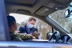 PORTSMOUTH, Va. (March 18, 2020) – Lt. j.g. Katherine Baile, an emergency nurse, conducts a practice screening at Naval Medical Center Portsmouth’s (NMCP) COVID-19 drive thru screening and triage site outside of NMCP’s Emergency Department (ED) on March 18.