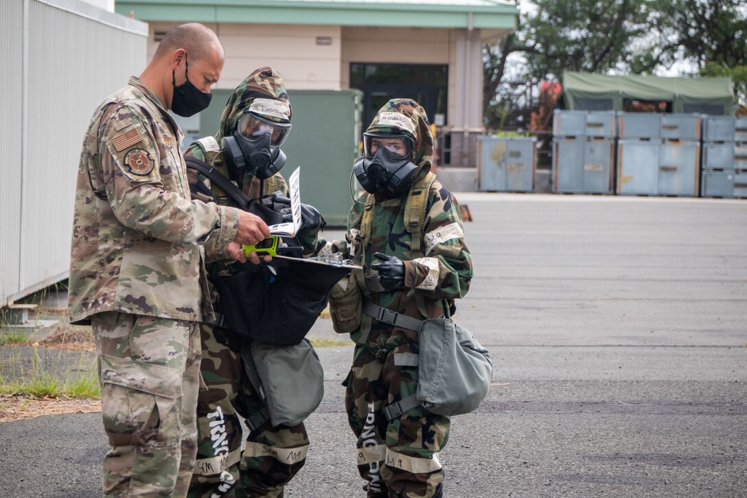 Master Sgt. Kareem Fuertes, 154th Civil Engineer Squadron Emergency Management Flight NCO-in-charge, and Airmen from the 154th Force Support Squadron conduct Chemical, Biological, Radiological, Nuclear and Explosive training February 23, 2021, at Joint Base Pearl-Harbor-Hickam, Hawaii. The scenario was part of a weeklong Home Station Readiness Training event to prepare members to operate in a series of conditions that may occur during a deployment or natural disaster. (U.S. Air National Guard photo by Staff Sgt. John Linzmeier)