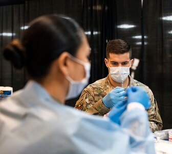 Air Force officer prepares COVID-19 vaccine.