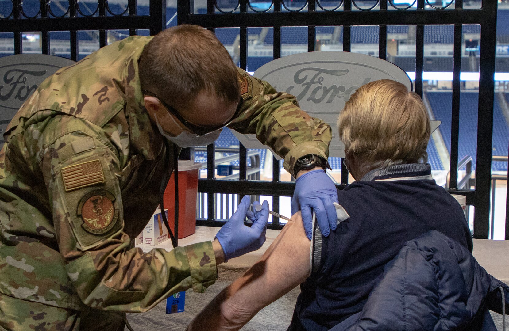 Airman administers COVID-19 vaccine.