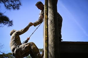 U.S. security forces Airmen with the 165th Security Forces Squadron, Georgia Air National Guard, complete an 11-task obstacle course Mar. 12, 2021 during a physical assessment try-out for the new 165th Strategic Response Team that the 165 SFS is starting. The assessment requires each defender to complete an official Air Force Physical Fitness Test, a timed obstacle course individually and again as a team, a ¼ mile ruck march while carrying a telephone pole as a team while wearing full combat gear and a gas mask, shooting box drills with a rifle and a pistol and lastly, an interview and feedback session. (U.S. Air National Guard photo by Tech. Sgt. Caila Arahood)