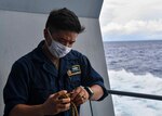 Seaman Dion Dumayas winds up a line on board the Expeditionary Sea Base USS Hershel “Woody” Williams (ESB 4) in the Horn of Africa, Feb. 13, 2021. Hershel Williams is operating in the Sixth Fleet Area of Operations to conduct interoperability training and building strategic partnerships with their African partners and Allied nations.