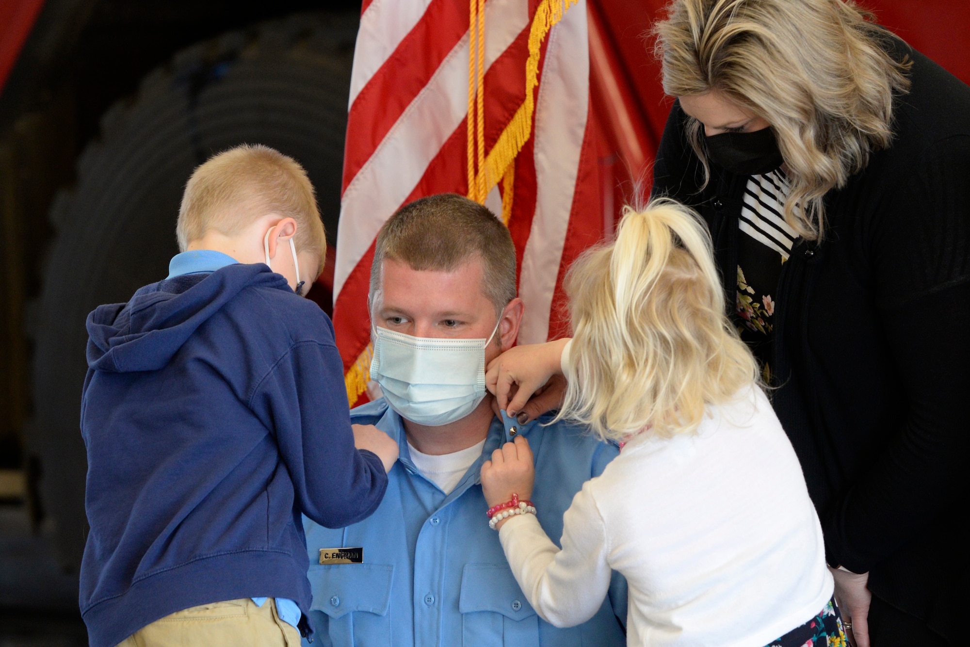 Air Force firefighter Lt. Chad Engman with the 788th Civil Engineer Squadron, is pinned on by his children, Cameron and Lexi, and wife Leah during a promotion ceremony at Wright-Patterson Air Force Base, Ohio on Monday, March 29, 2021.