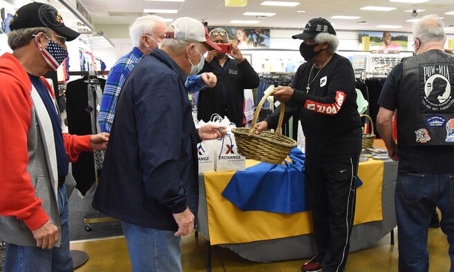 Retired Servicemen receive a commemorative lapel pin in recognition of Vietnam War Veterans Day at the Base Exchange, Mar. 29, 2021, on Columbus Air Force Base, Miss. According to the Defense POW/MIA Accounting Agency, of the remaining 1,246 Americans still unaccounted for in Vietnam, 470 are in a “non-recoverable” category. (U.S. Air Force Photo by Elizabeth Owens)