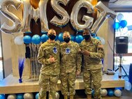 Military members pose for group photo at promotion ceremony