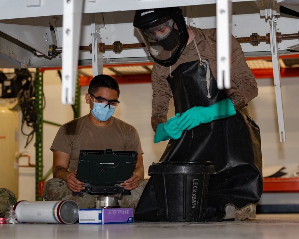 U.S. Air Force Senior Airman Efren Estrada and Airman 1st Class Brandon Wilson, 1st Maintenance Group fuels technicians, prepare a fuel tank for installation at Joint Base Langley-Eustis, Virginia, March 15, 2021.