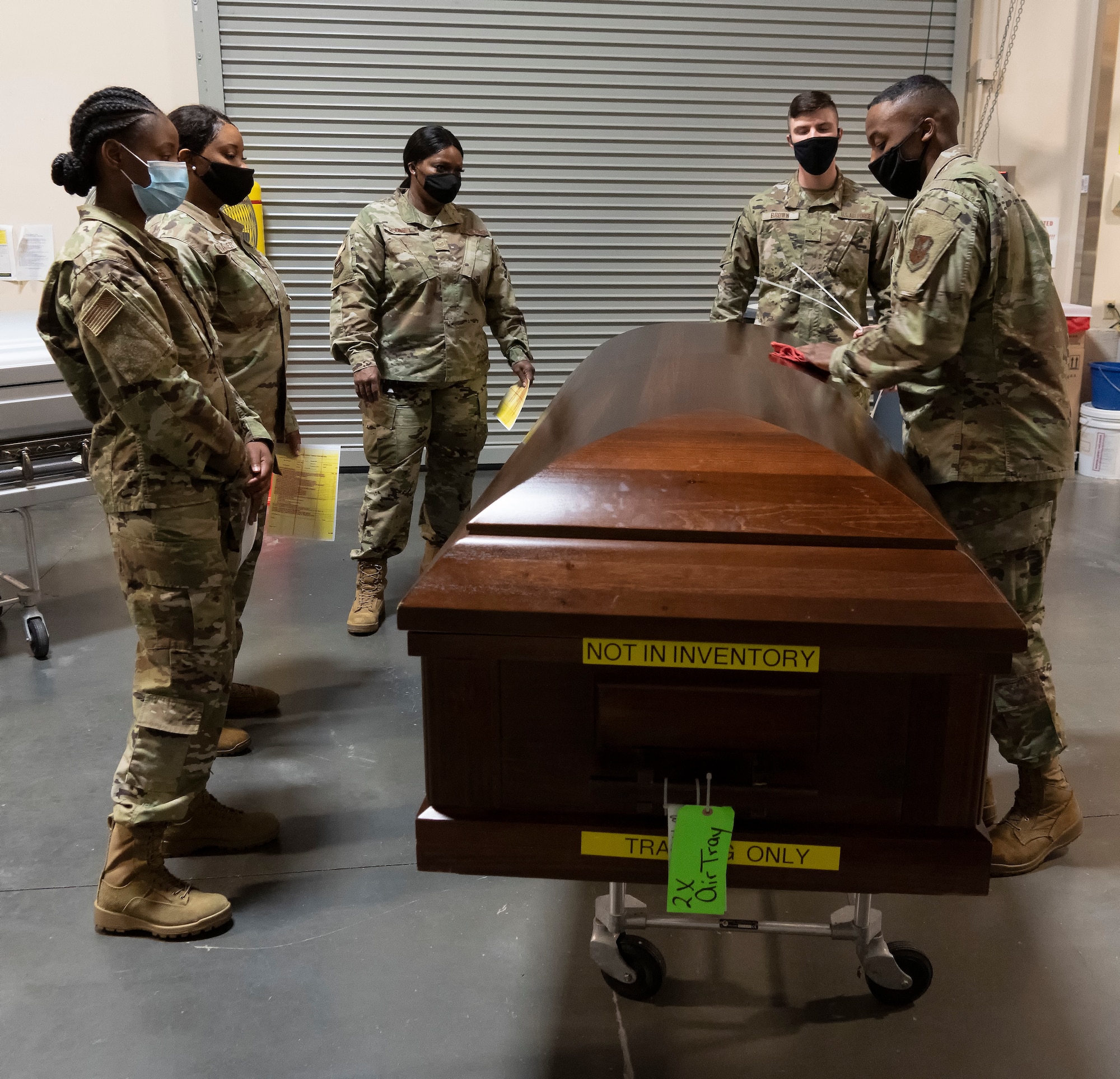 Air Force Mortuary Affairs Operations members demonstrate how to inspect caskets during the Force Support Contingency Training-Mortuary course at Dover Air Force Base, Delaware, Mar. 23, 2021. It is AFMAO's mission and privilege to fulfill the nation's sacred commitment of ensuring dignity, honor and respect to the fallen, and care, service and support to their families. (U.S. Air Force photo by Jason Minto)