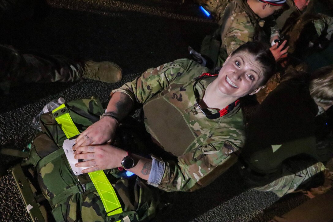 Despite having completed an 18.6 mile march carrying a 31 pound rucksack,  Sgt. 1st Class Kristen Bell, Civil Affairs Team Sergeant, 404th Civil Affairs Battalion (Airborne), is all smiles. Her time of 4 hours, 38 minutes earned her the Norwegian Foot March badge for wear on her Army Service Uniform.