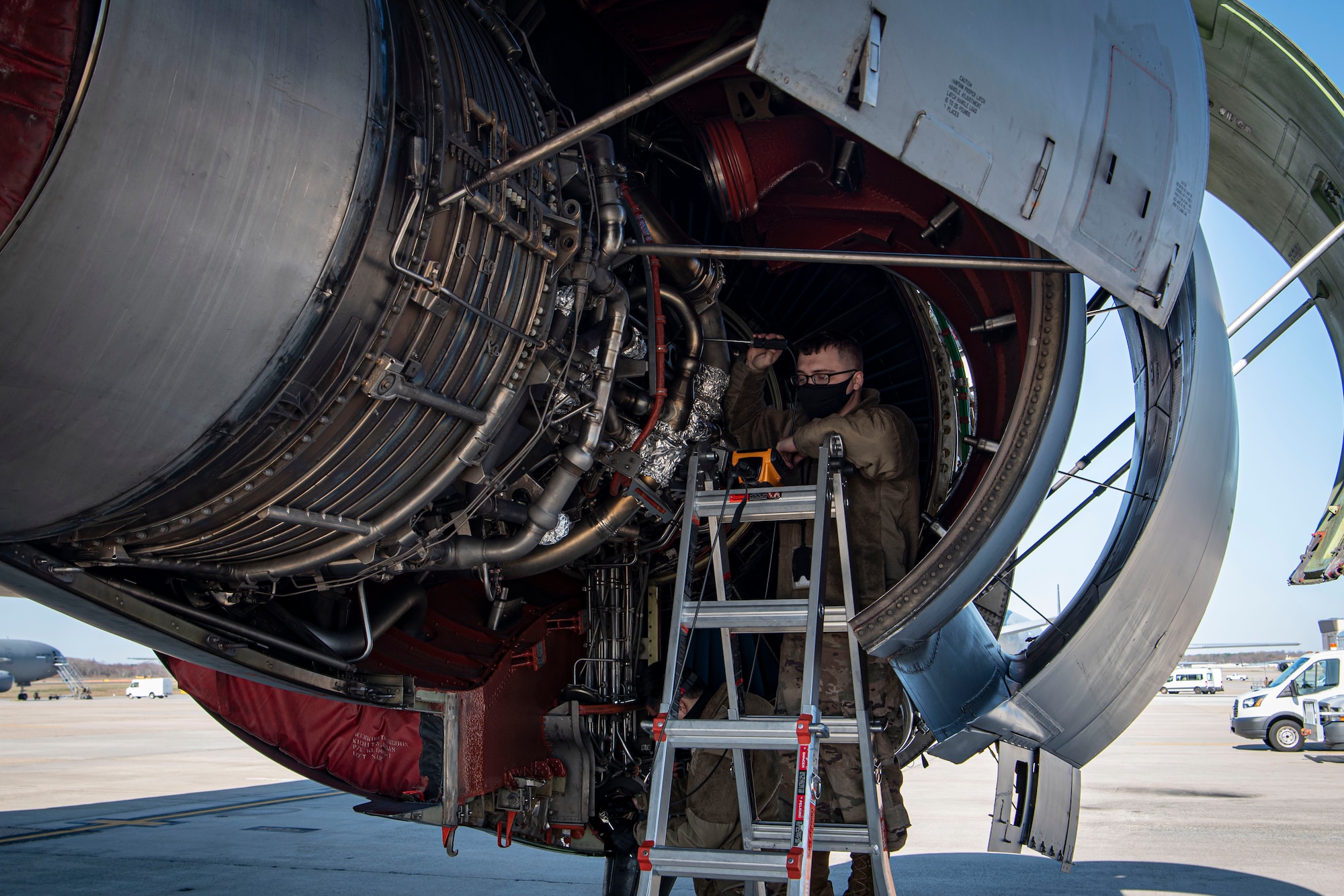 Photo of an Airman performing a borescope inspection on a KC-10 Extender compressor section.
