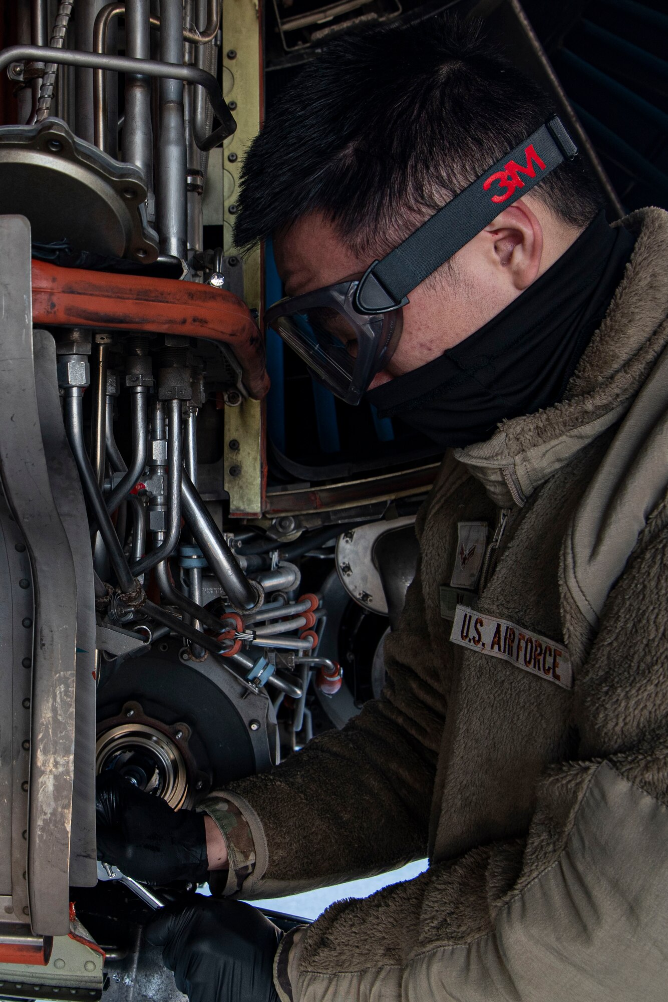 Photo of an Airman turning the compressor section of a KC-10 Extender.