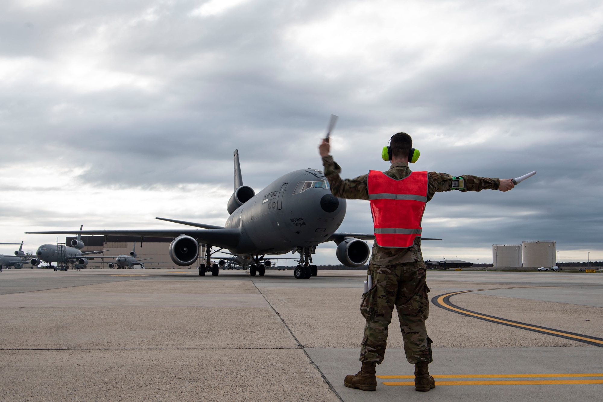 Photo of an Airman marshalling a KC-10 Extender.