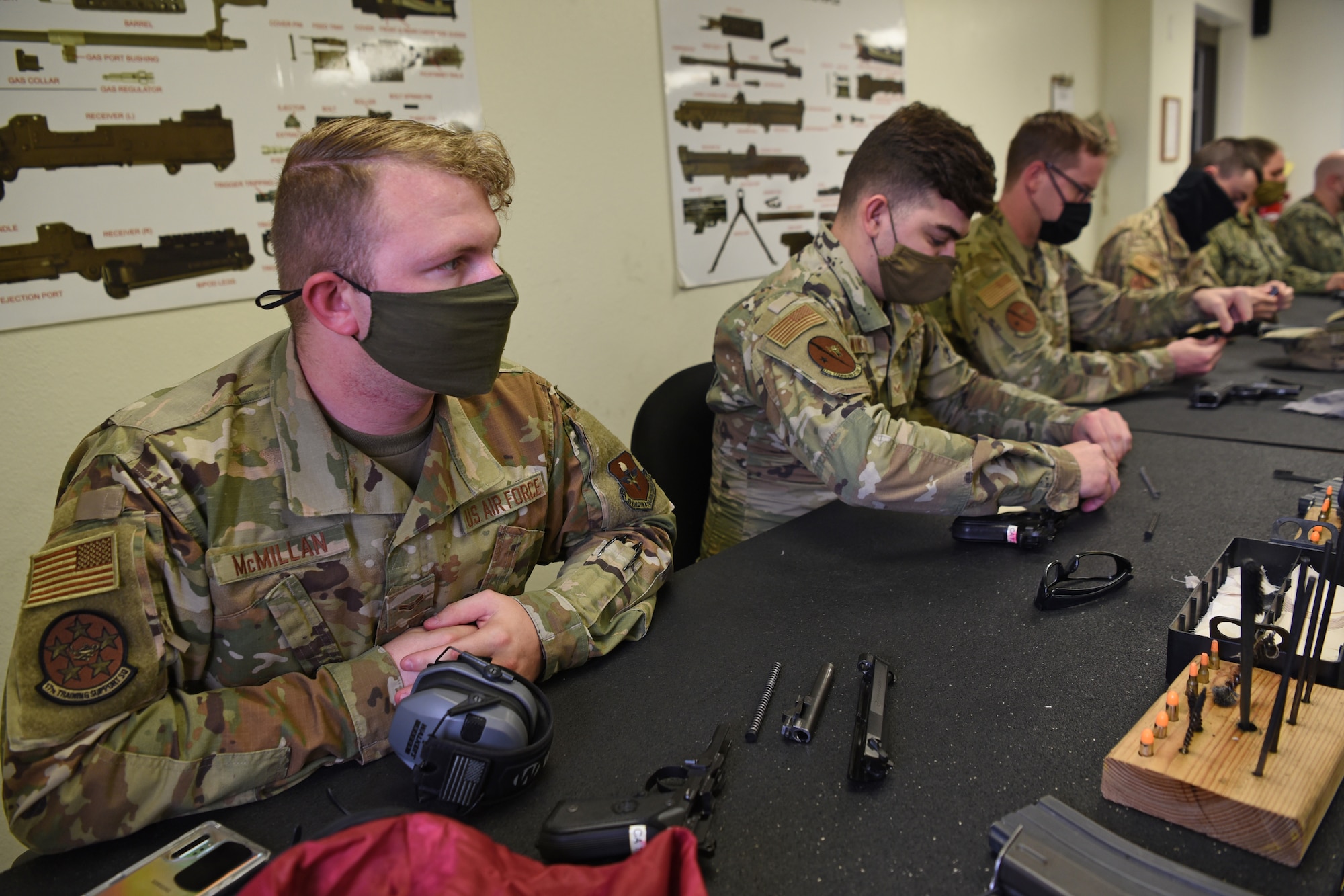U.S. Air Force Airman 1st Class Eugene McMillan, 17th Training Support Squadron cyber security officer, actively listens to an information brief during the Shooting in Excellence competition at the firing range, on Goodfellow Air Force Base, Texas, March 30, 2021. The briefing reiterated the importance of the familiarization with the equipment and following the proper safety procedures. (U.S. Air Force photo by Senior Airman Abbey Rieves)
