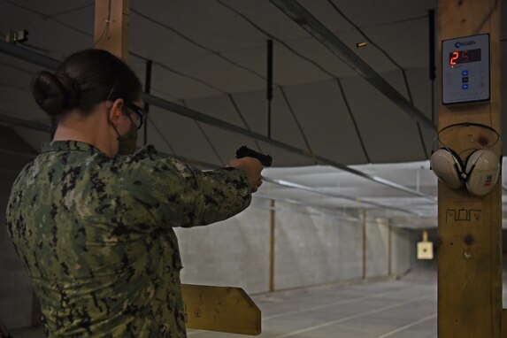 U.S. Navy Petty Officer 3rd Class Breanna Cherchio, Navy Center for Information Warfare Training Detachment Goodfellow cryptologic technician student, fires rounds during the Shooting in Excellence competition at the firing range, on Goodfellow Air Force Base, Texas, March 30, 2021.  Over 30 joint service members competed throughout a two-day period to win bragging rights and a pistol badge. (U.S. Air Force photo by Senior Airman Abbey Rieves)